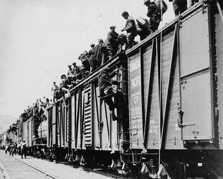 Strikers from unemployment relief camps climbing on boxcars in Kamloops, British Columbia