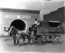 The Thurman & Loveday building with a sign for the Appalachian Exposition, with a horse drawn wagon for mail Knoxville & Sevierville Fast Mail hack.png