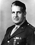 Head and shoulders view of man in military uniform with decorations.