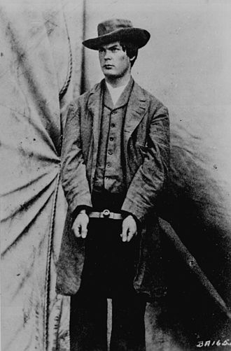 Mosby partisan Lewis Powell modeling for photographer Alexander Gardner the hat and overcoat he wore when he attacked William Seward April 1865. Lewis-Payne.jpg