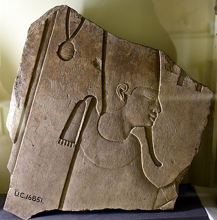 Limestone relief fragment shows an unidentified pharaoh wearing the heb-sed robe, white crown of Upper Egypt, and menat. From Koptos, Egypt. 12th Dynasty. Petrie Museum
