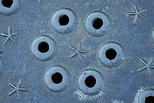 Pick holes in manhole cover, Palo Alto, California, USA Manhole cover pickholes.jpg