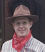 A man wearing a kerchief around his neck