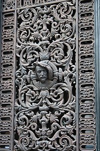 Renaissance Revival cast iron door window grill of a building on Rue du Bac from Paris