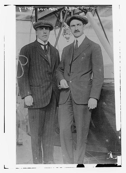 Porte and Curtiss as they appeared in The New York Times 10 March 1914, standing next to a Model F.