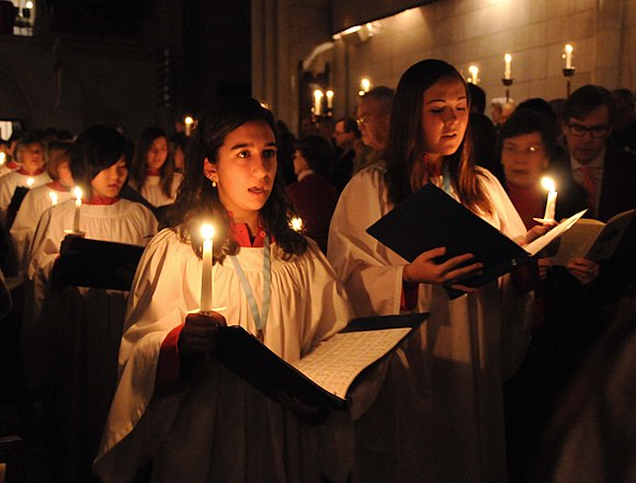 A church choir singing in procession at a service of Nine Lessons and Carols