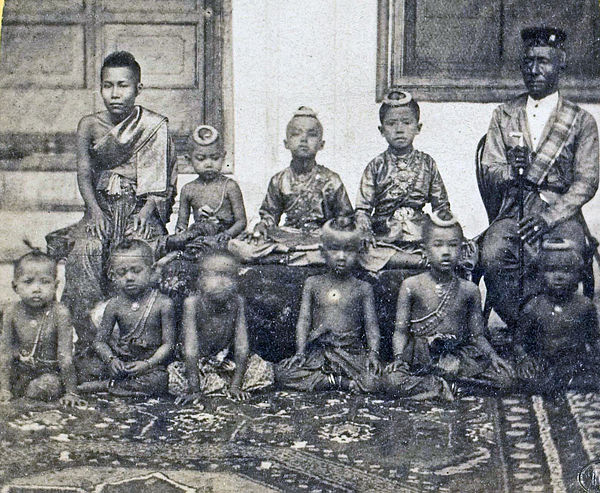 King Mongkut (far right) with his heir Chulalongkorn seated next to him and some of his other children. A wife is seated at left.