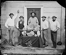 Bernhardt Holtermann (2nd from left), Richard Ormsby Kerr (centre) and Beyers (2nd from right), with reef gold from Star of Hope mine, 1872, attributed Henry Beaufoy Merlin Star of Hope Mine, NSW.jpg