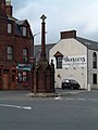 The cross in Turriff, Aberdeenshire comprises a 16th-century pillar and cruciform top raised on a 19th-century plinth.