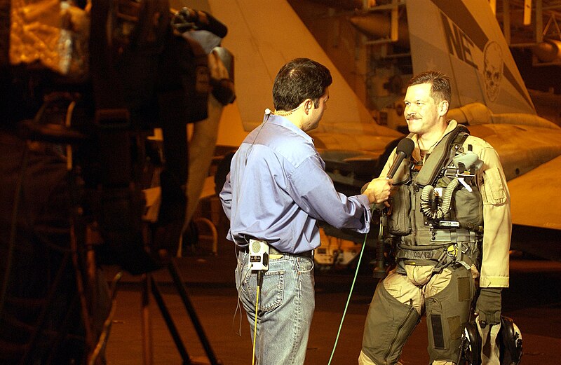 File:US Navy 030322-N-1397H-001 U.S. Navy Capt. Mark Fox, Commander Carrier Air Wing Two (CVW-2), is interviewed by a CNN reporter in the ship's hangar bay.jpg