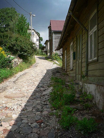A cobblestone path and old wooden houses in Viljandi