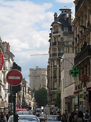 A street in Vincennes, with the keep of the Vincennes medieval castle in the background