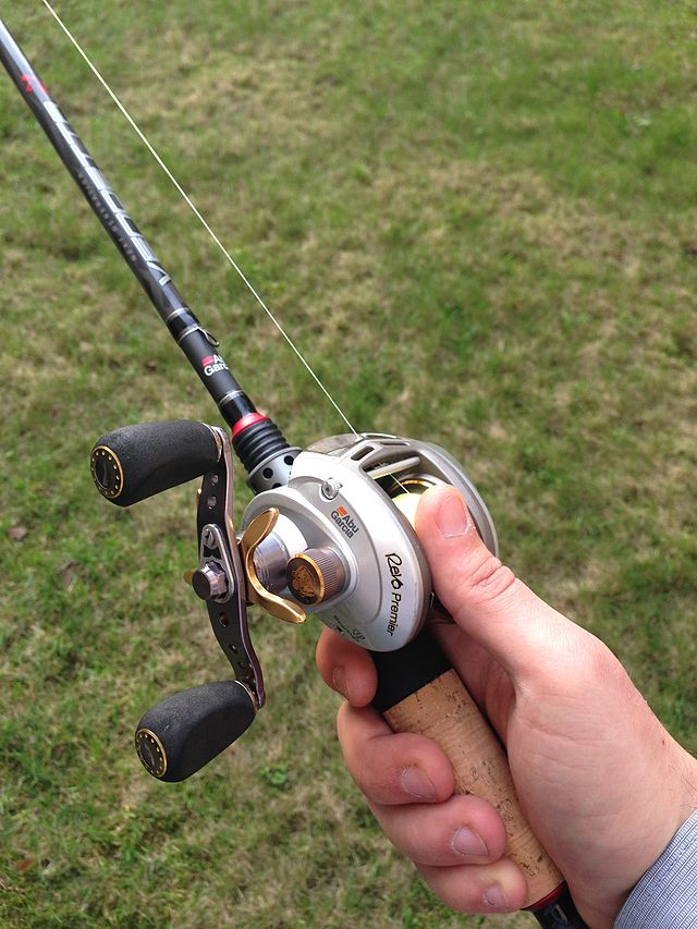 Close up detail of a bait casting deep sea fishing reel and rod set up with  a jig and large hook. Shallow depth of field Stock Photo - Alamy