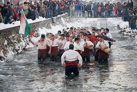 A traditional Bulgarian all-male horo dance in ice-cold water on Theophany