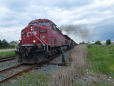 A westbound CP freight train pulls away from a passing siding after track clearance in Bolton, Ontario. It is headed by four GE AC4400CW locomotives (8627, 9615, 8629, and 8609).