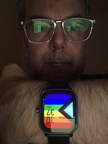 Person showing LGBTQ pride smart watch face