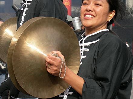 Chinese-style crash cymbals in use