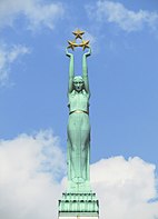 A woman in a gown holding up three gold stars