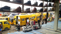 A collection of minibuses outside a train station in suburban Mwera