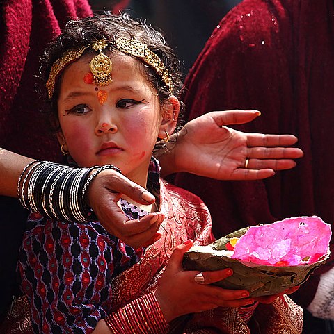 A young Nepali Hindu devotee during a traditional prayer ceremony at Kathmandu's Durbar Square.
