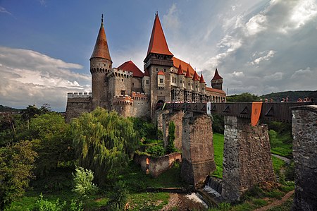 A castle with a large courtyard, a fortified entrance and two towers