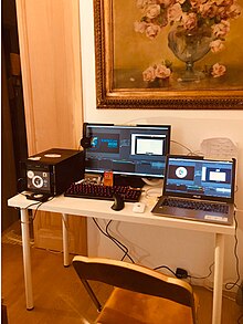 Two on computers on a desk