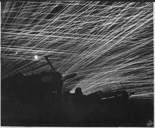 Japanese night raiders are greeted with a lacework of anti-aircraft fire by the Marine defenders of Yontan airfield... - NARA - 532363.tif