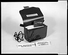 A Mounted Ration Heating Device, a prototype Flameless Ration Heater. Service members would power the device using the attached cable and a running vehicle. Up to four MRE pouches could be heated at once. Mounted Ration Heating Device (MRHD).jpg