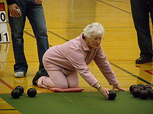 A player kneeling and using the pincer grip. This photo was taken during the semifinal of the fours at the '07 nationals. New Zealand Indoor bowling.jpg