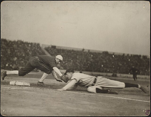 Pickoff attempt during one of the games. Frank Chance slides in safely past the tag of Jiggs Donahue.