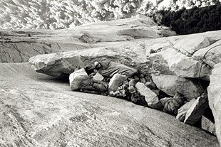 Rock climber Chuck Pratt bivouacking during the first ascent of the Salathe Wall on El Capitan in Yosemite Valley in September 1961. Pratt bivouac by Tom Frost.jpg