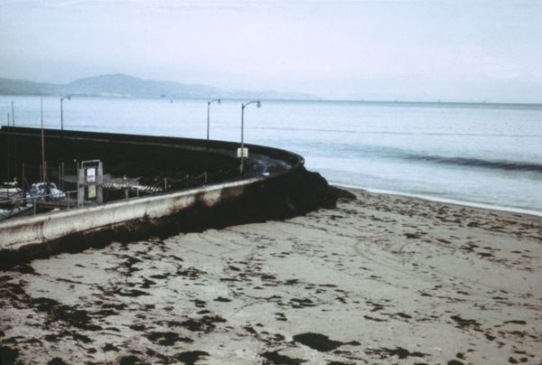 Oil piled up at the seawall near the Santa Barbara Harbor. Note the blackness of the incoming wave; the water has a thick layer of oil on top.