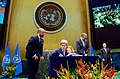 Photo: John Kerry with Granddaughter Dobbs-Higginson (Ban Ki-moon behind) signing the COP21 Climate Change Agreement (Paris Agreement) at UN General Assembly Hall on Earth Day 2016.