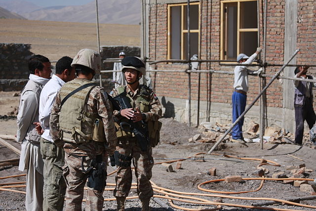 Soldiers of the SAF speaking with local contractors at the site for the Singaporean-funded Bamyan Regional Health Training Center in Afghanistan