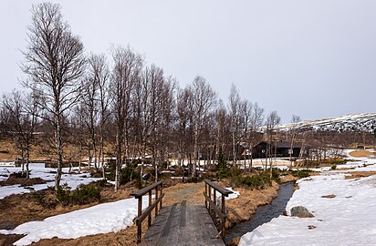 Small wooden bridge and wooden cabins near Rondane Høyfjellshotell, Rondane, Norway