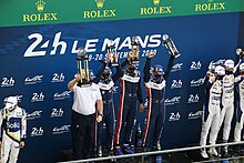 Paul Di Resta, Phil Hanson and Filipe Albuquerque on the podium to receive their trophies for clinching the LMP2 win in the 2020 Le Mans 24 Hours United Autosports Le Mans 24 Hours 2020 3.jpg