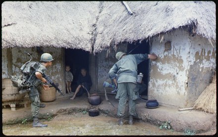 U.S. soldiers searching a village for potential Viet Cong during the Vietnam War, 1966