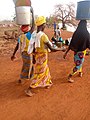 Women_walking_bare_footed_to_the_dam_for_water_in_Northern_Region_of_Ghana