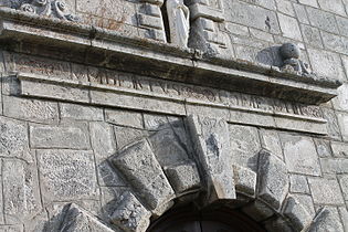 Détails du portail avec inscription latine.