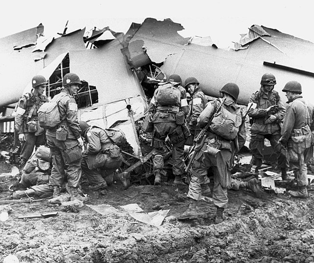 Men of the 101st Airborne Division inspect a broken glider, September 1944.