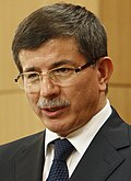 Ahmet Davutoğlu answering questions from the media in London, 8 July 2010 (4774547672) (cropped).jpg