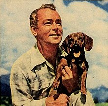 Alan Ladd with his dachshund Red Beret, taken during filming of Saskatchewan, 1953