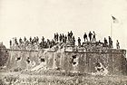 American troops raising the Flag at Fort San Antonio De Abad, Malate, Philippines (1899).jpg