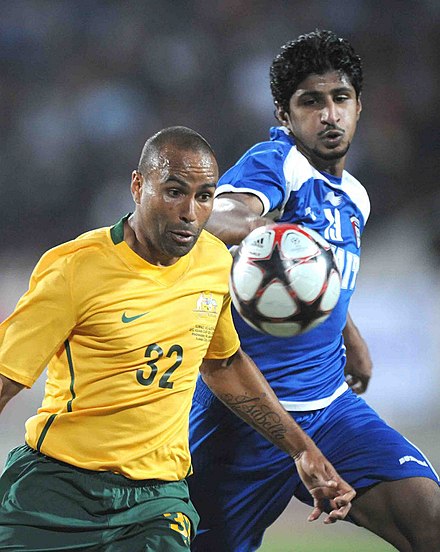Thompson (left) playing for Australia against Kuwait in 2010