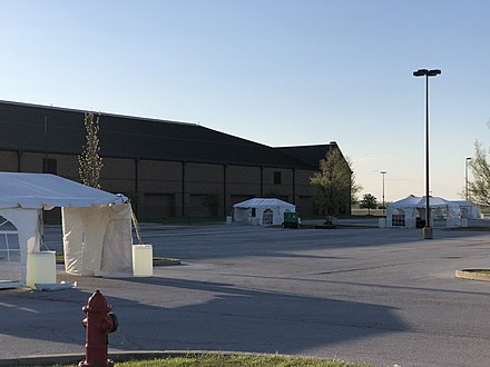 A temporary drive-in testing site for COVID-19 set up with tents in a parking lot