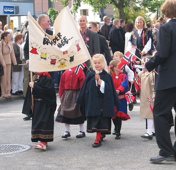 The kindergarten part of a Children's parade. The Gákti, the traditional clothing of the Sami people, is used by one of the small children.