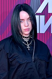 Billie Eilish's debut album, When We All Fall Asleep, Where Do We Go?, was the best performing album of 2019. Eilish became the first artist born in the 21st century to have a number-one album on the Billboard 200. Billie Eilish 2019 by Glenn Francis.jpg