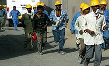 Migrant workers at the Burj Dubai Burj Dubai Construction Workers on 4 June 2007.jpg