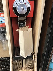 Coffee grinder at grocery store with paper bag for ground coffee
