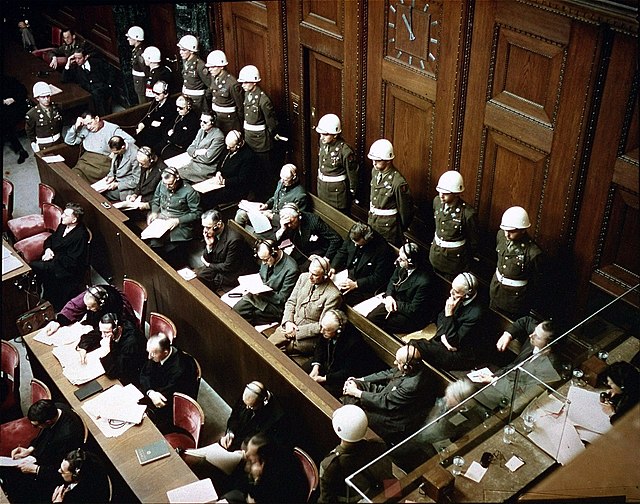 Nuremberg defendants at dock listening to simultaneous interpretation